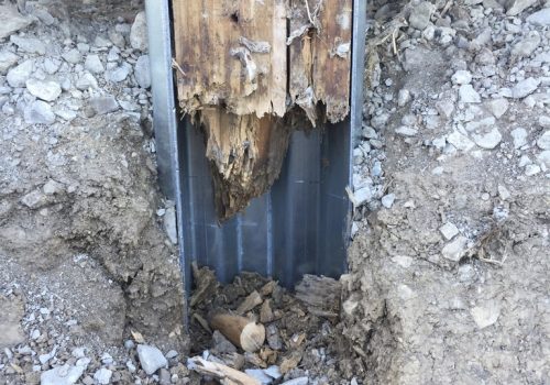 A rotted pole barn post awaiting repair is seen. The Pro Barn Saver knows how to prevent pole barn posts from rotting.
