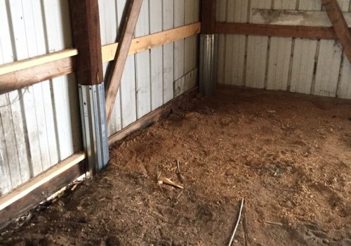 A repaired pole barn post is seen. The Pro Barn Saver knows how to prevent pole barn posts from rotting.